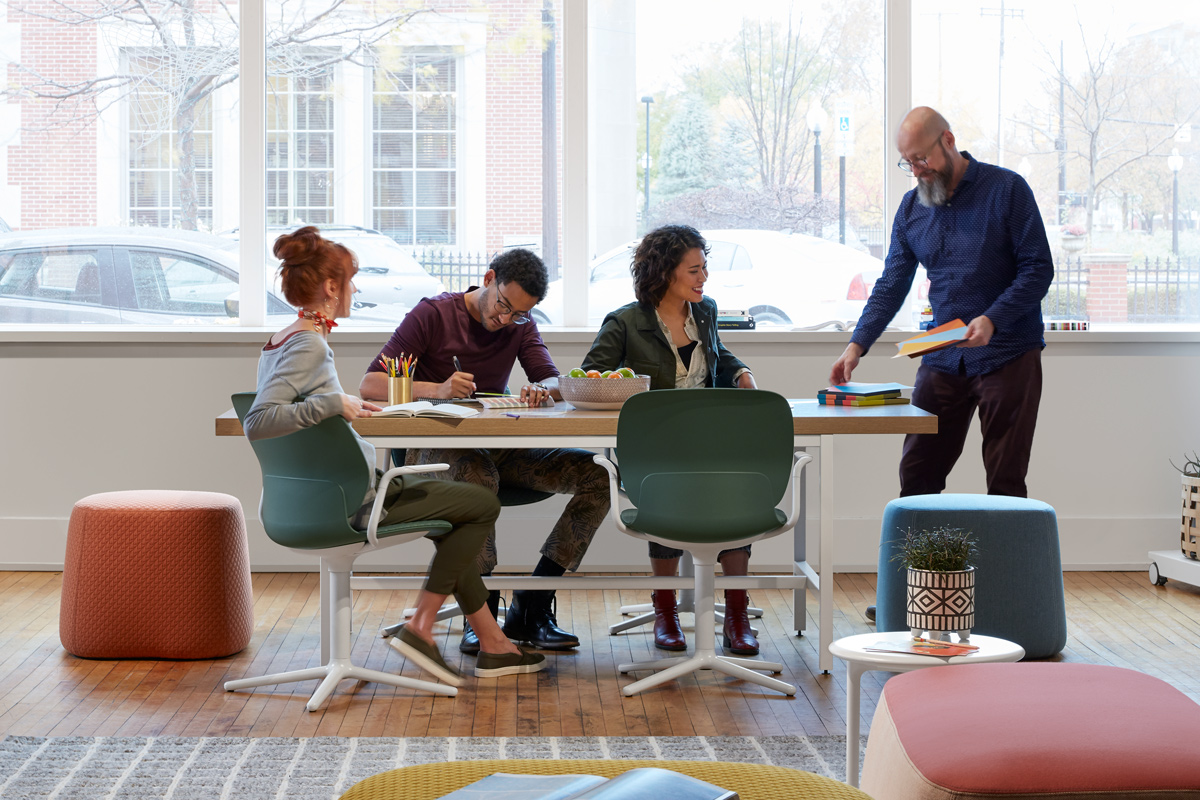 Group of people working and talking at a table